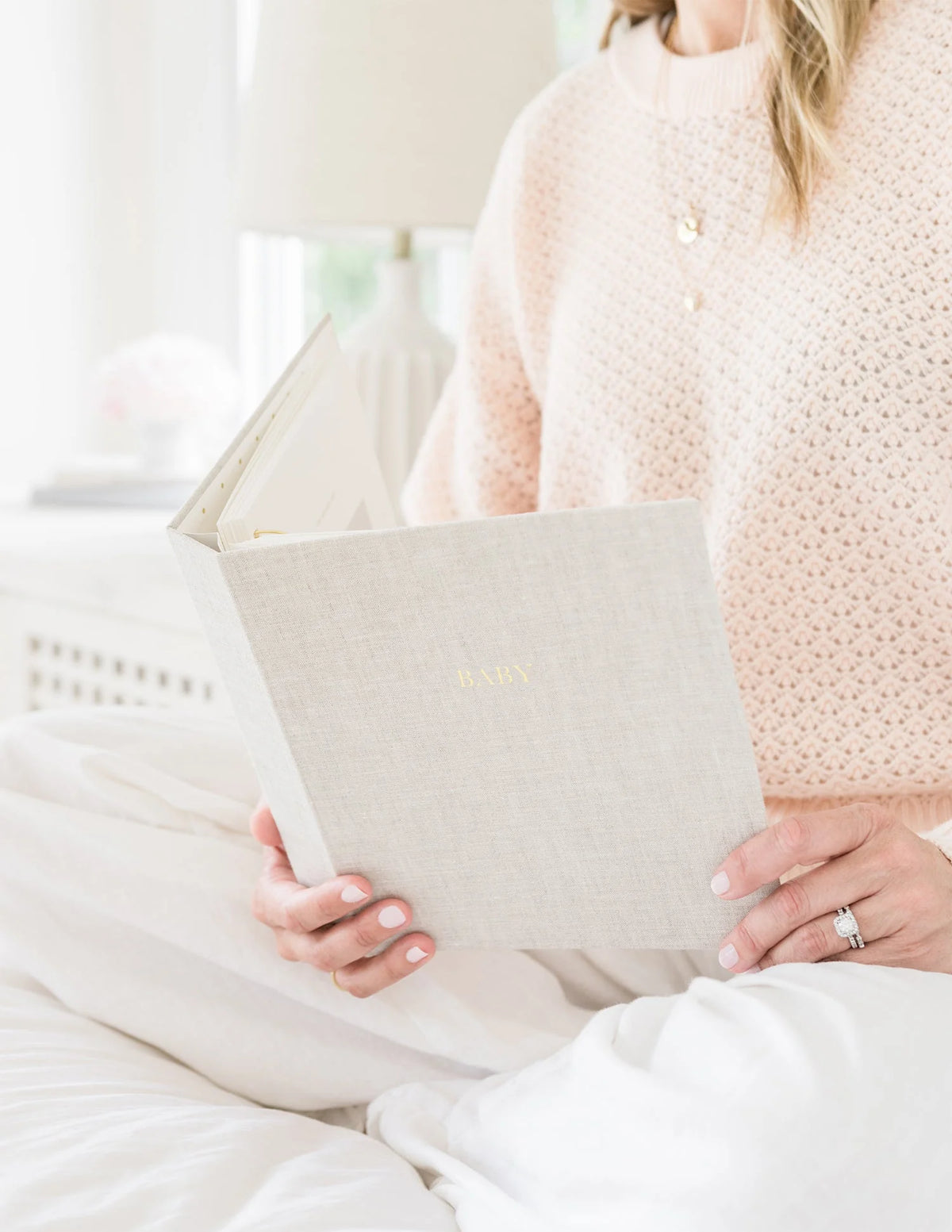 Sugar Paper baby book in flax, held