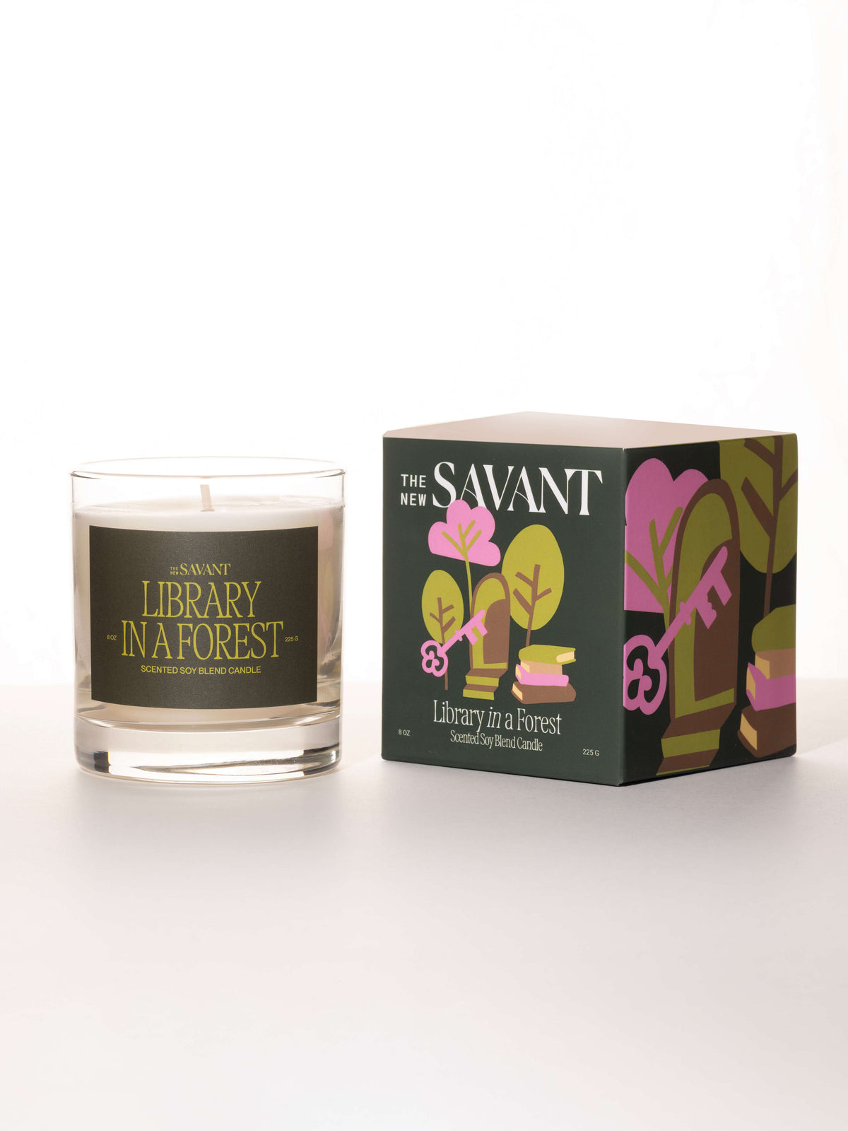 The New Savant Library in a Forest Candle in glass beside its illustrated box