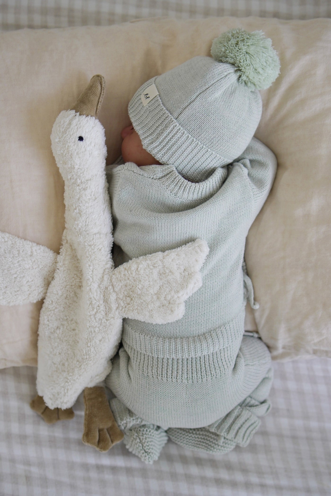The pom beanie and coordinating blanket in Light Sage