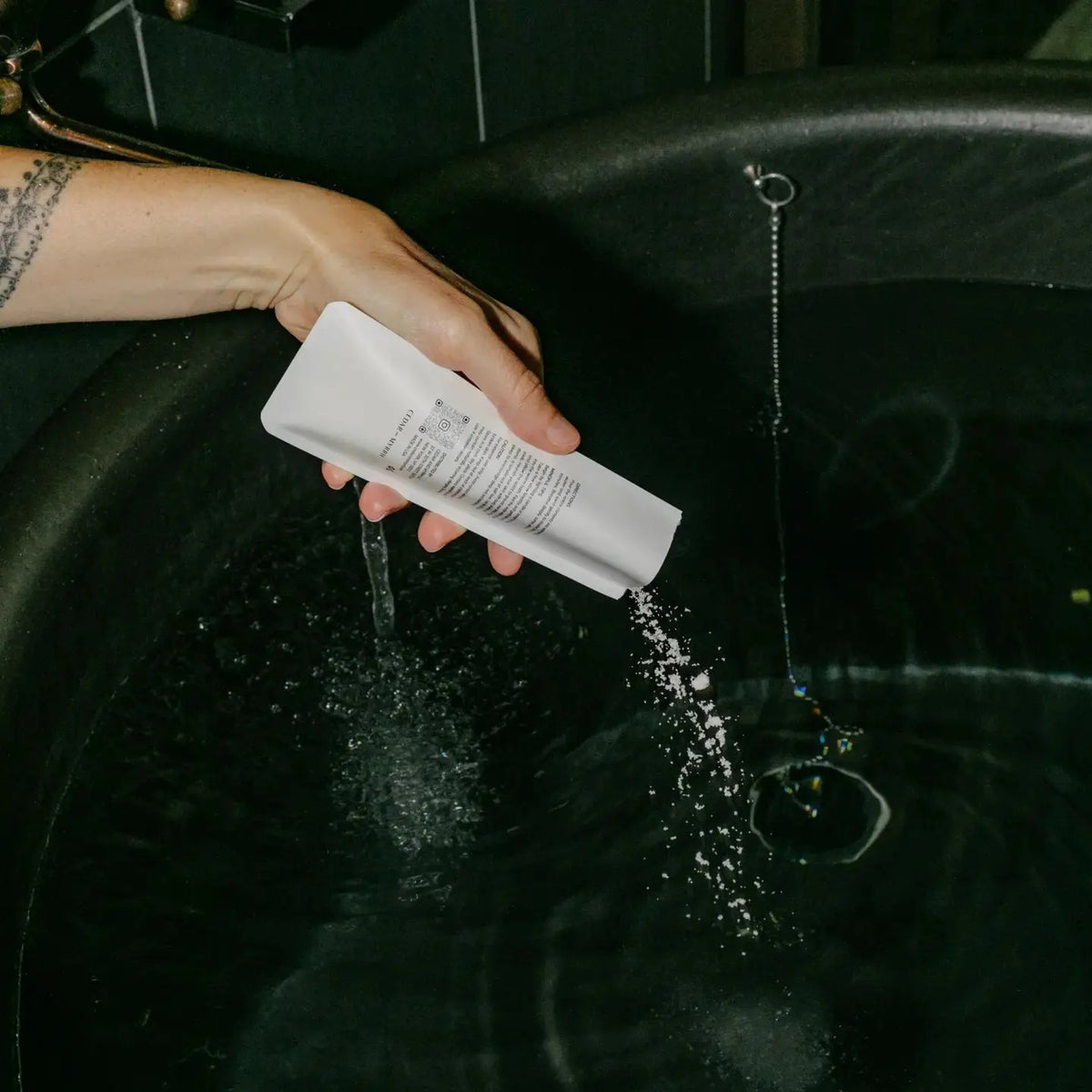 The Quiet Hours, Cedar & Myrrh hinoki bath salts poured into a running bath