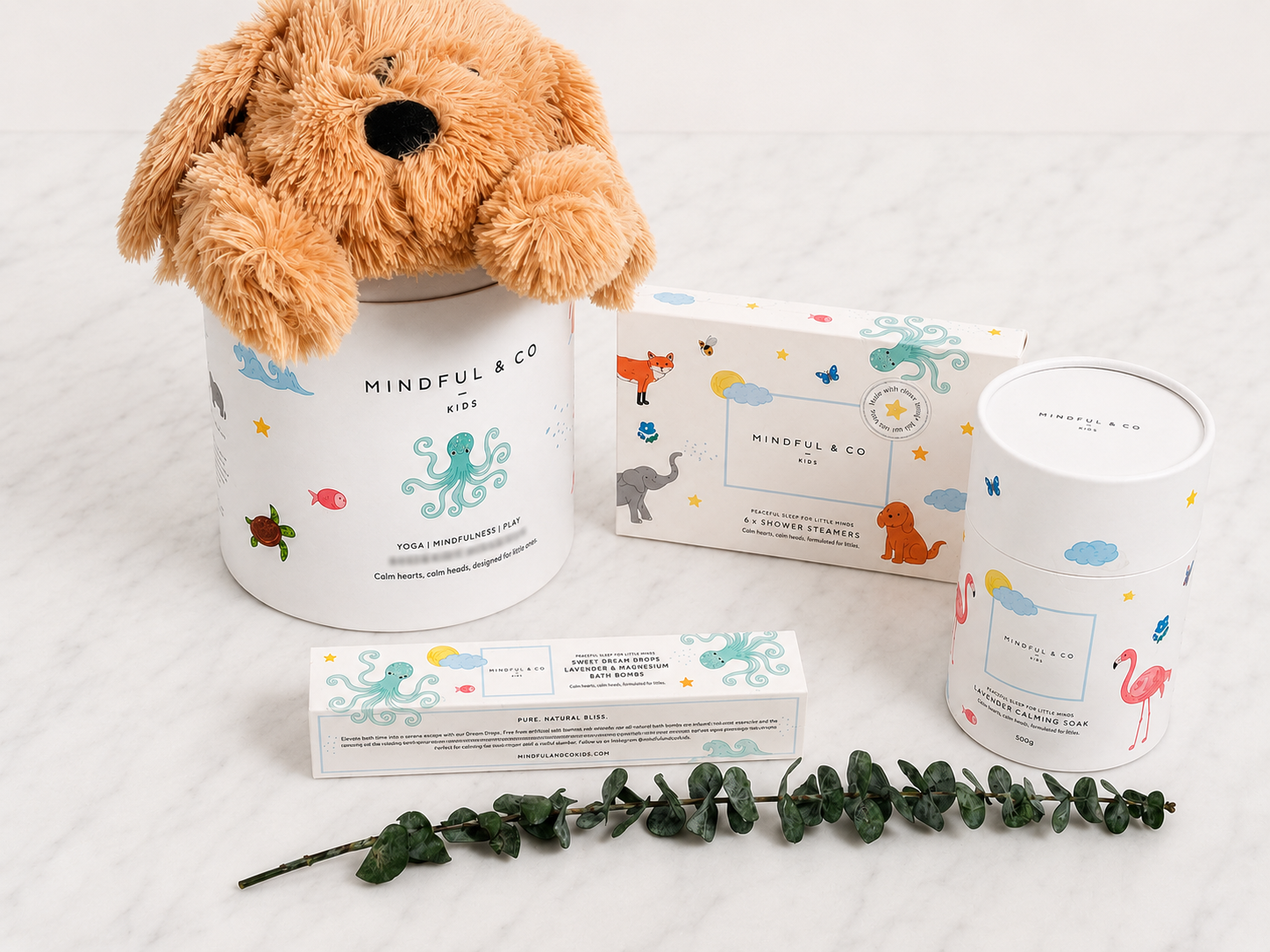The Wind Down Edit with a weighted puppy dog, sensory shower steamers, lavender magnesium calming soak, and Sweet Dream Drops bath bombs