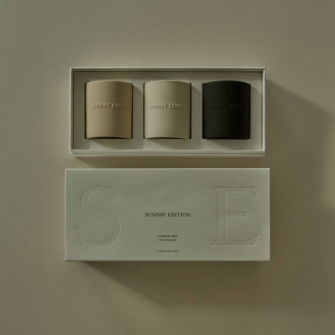 The Essential trio beside its lid, embossed with Sunday Edition