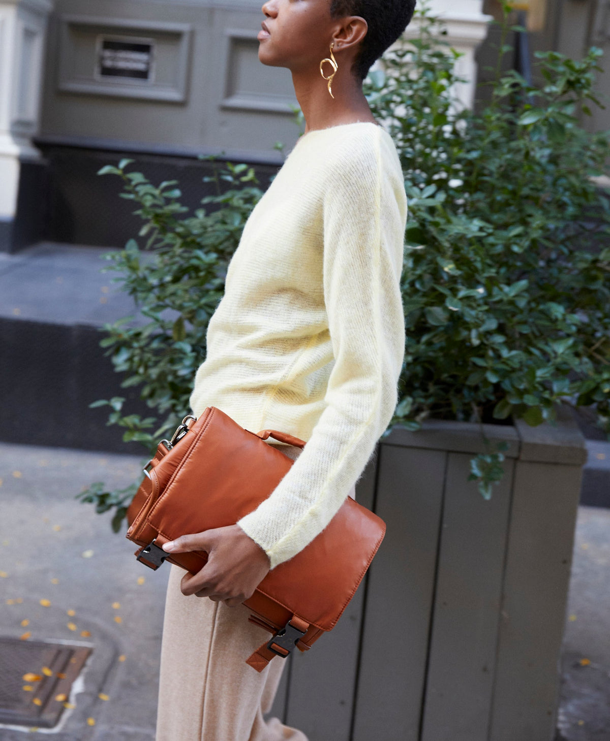 Caraa Baby Changing Kit in Clay carried as a clutch
