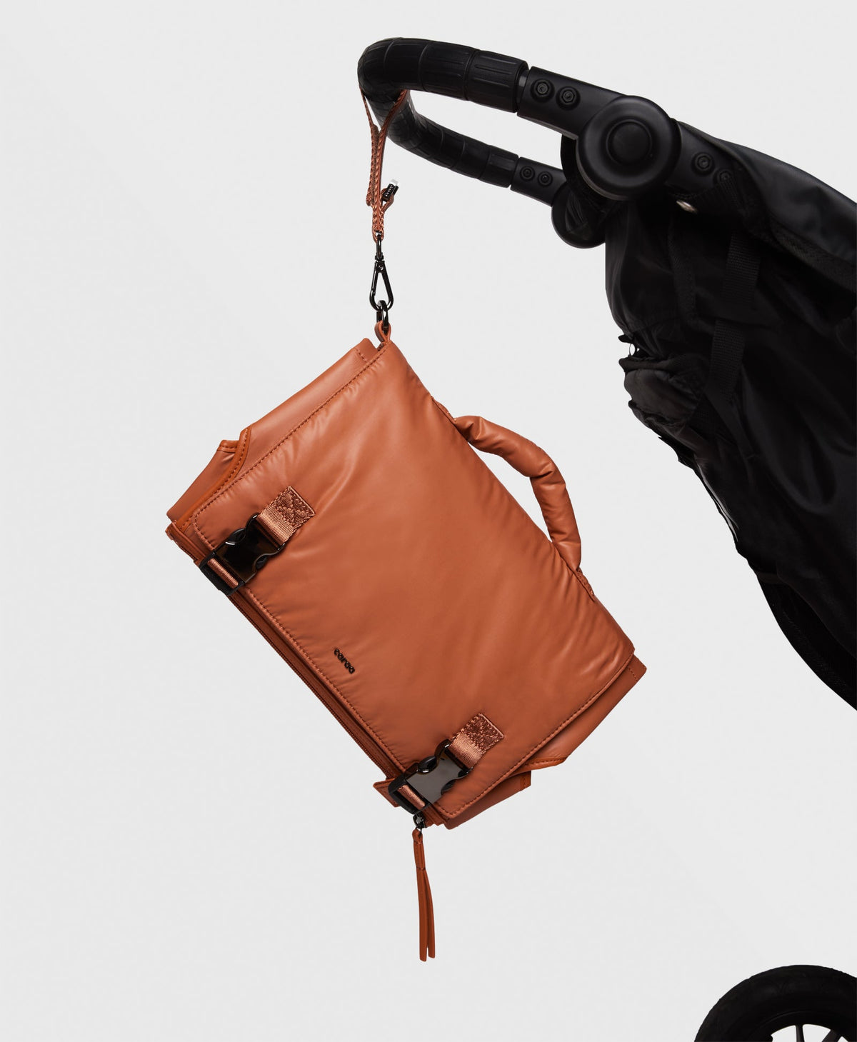 Caraa Baby Changing Kit in Clay hooked onto a stroller