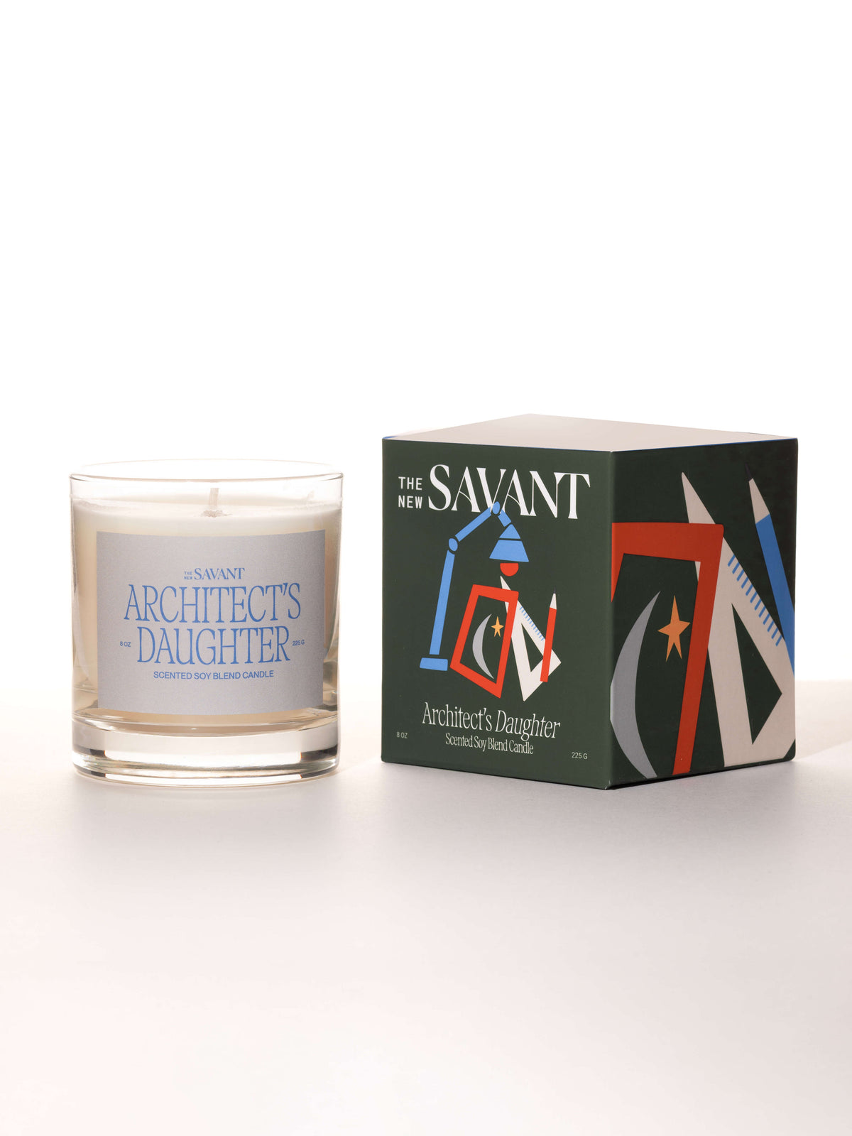 The New Savant Architect's Daughter Candle in glass beside its illustrated box