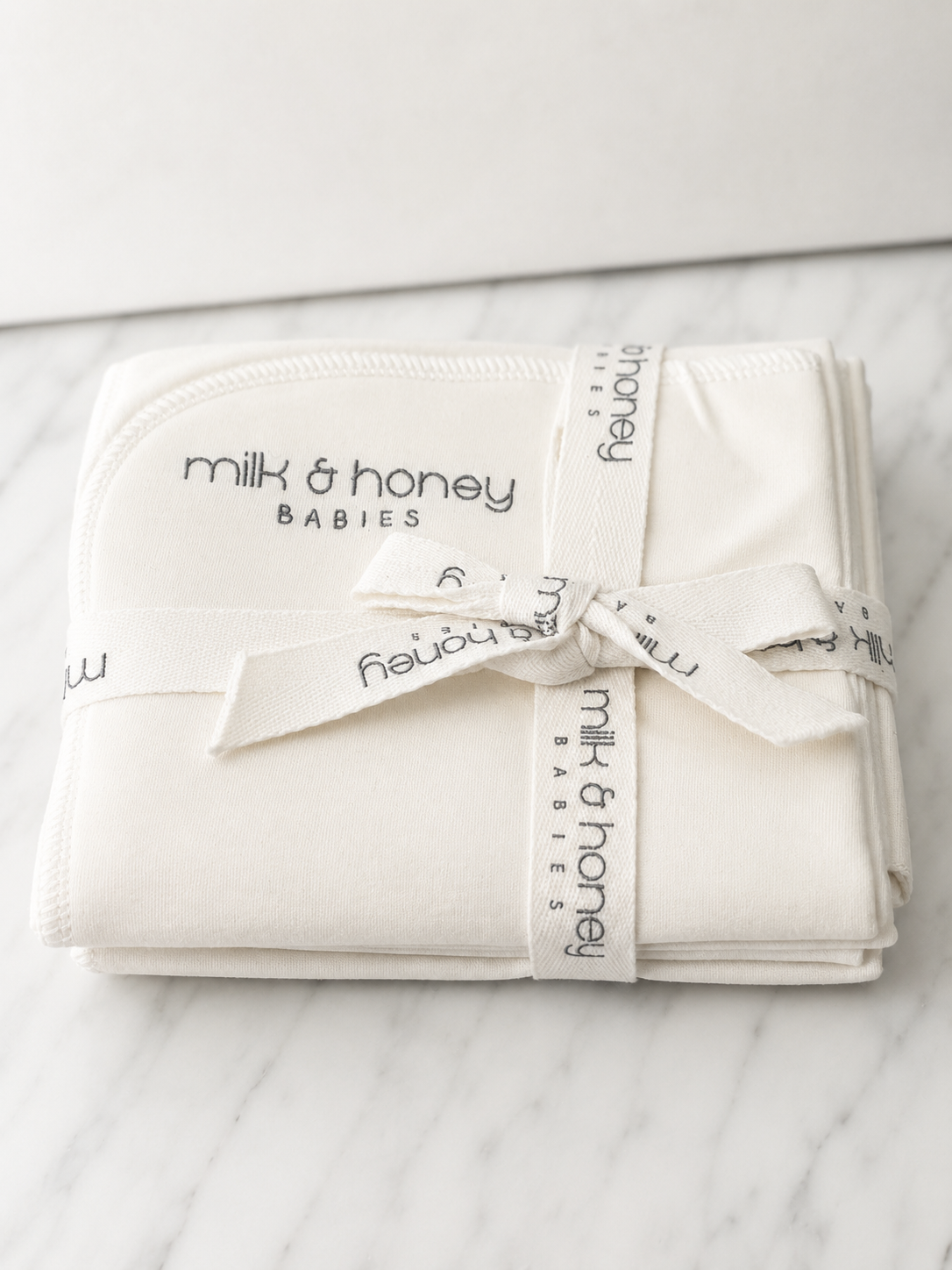 milk and honey babies organic burp cloths, set of four, tied with branded ribbon