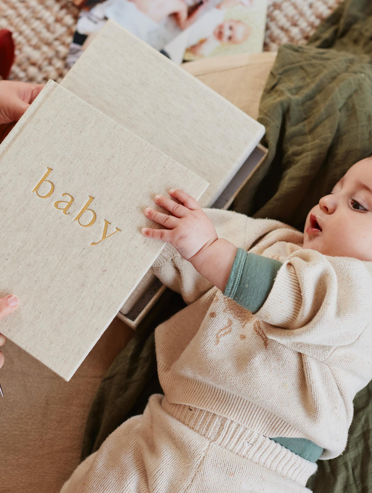 Baby book held beside a baby