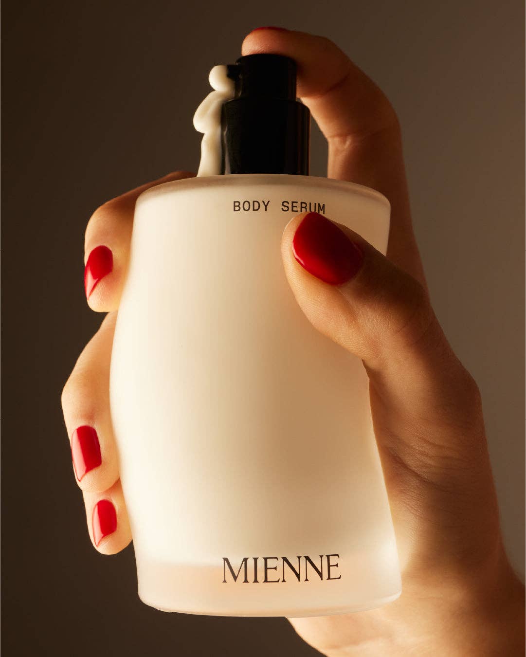 Mienne Body Serum in hand