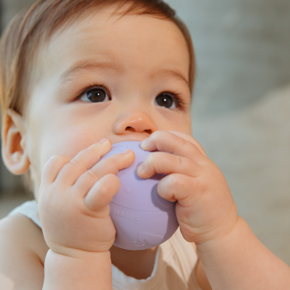 Baby using B Is For Ball as teether