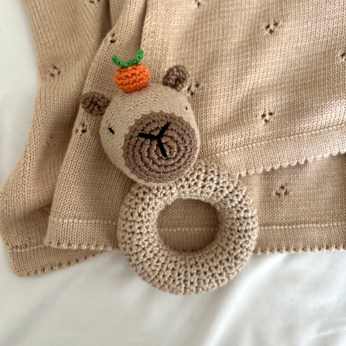 Cloverleaf Eyelet Knit Blanket in Tan, detail of the eyelets and picot edge
