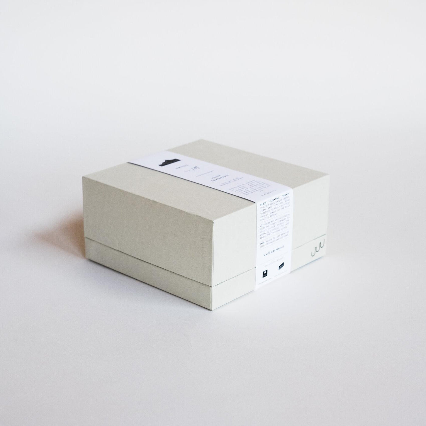 The soap in its open box, black foam bed