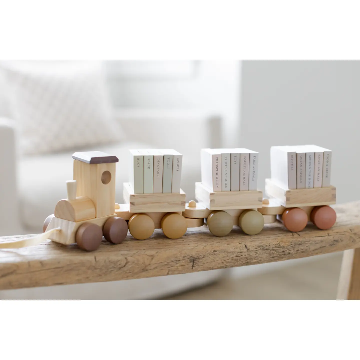 A wooden pull-along train carrying fifteen miniature board books